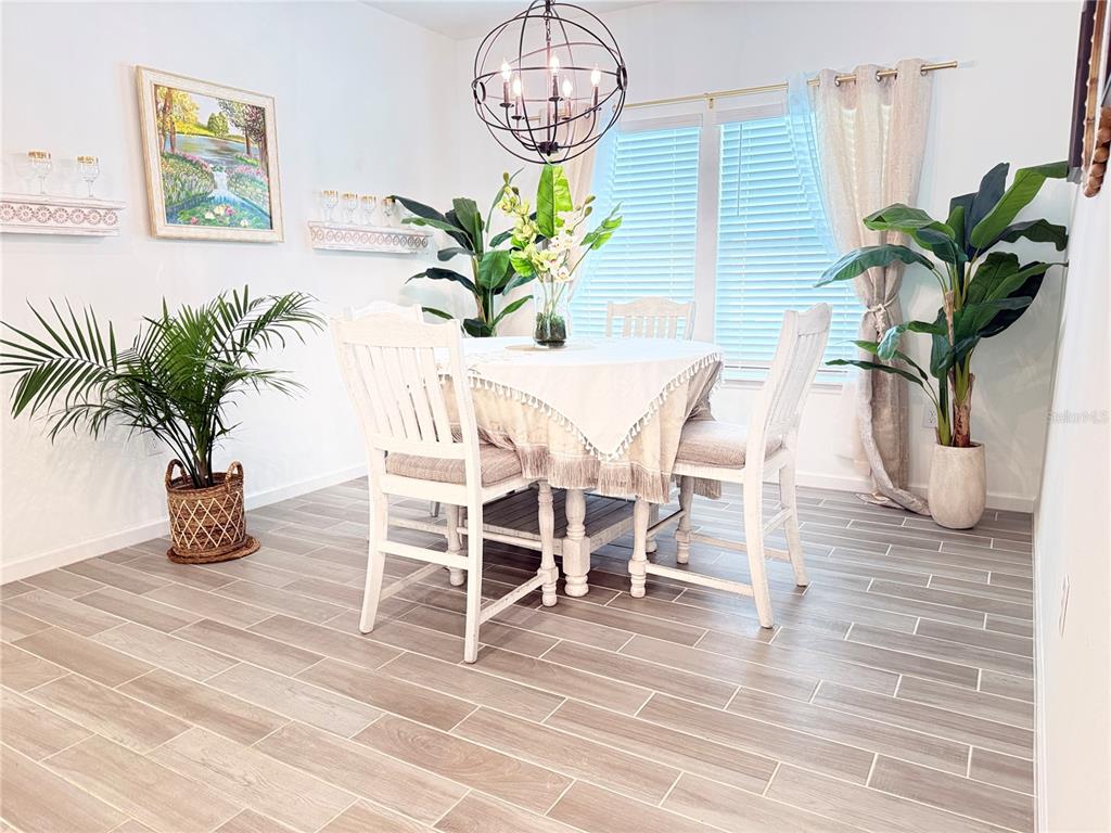 7656 Southwest 74th Loop Ocala, FL 34474 - Photo 10 of 95 a view of a dining room with furniture and a potted plant