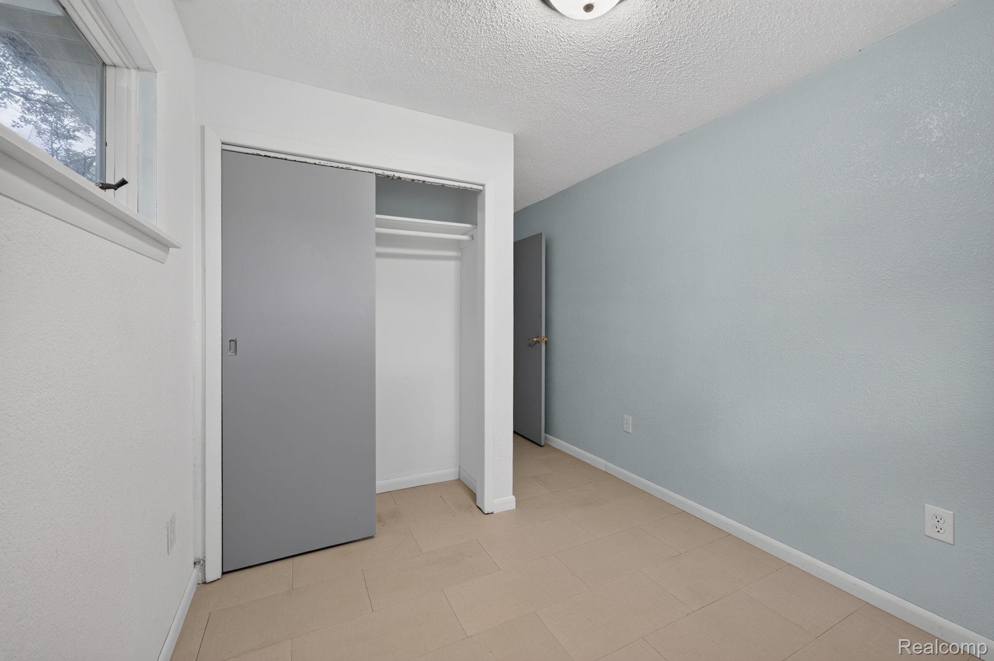 9288 Hilda Lane Flushing, MI 48433 - Photo 36 of 50 Room with light-toned flooring, white baseboards, and a light blue accent wall
