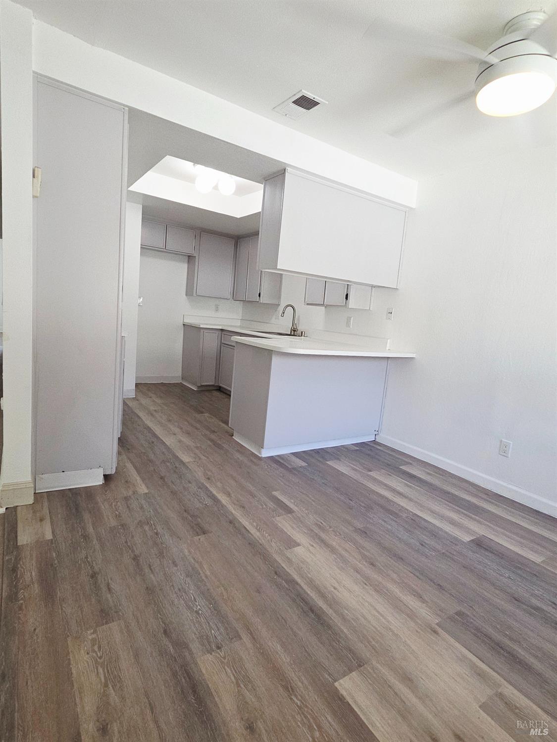 140 Del Rio Court, Unit 4 Vacaville, CA 95687 - Photo 9 of 25 a view of a kitchen with wooden floor and a sink
