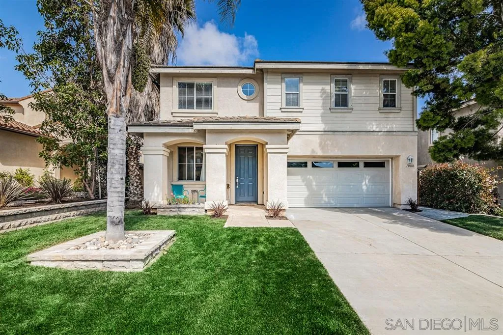 1088 Greenway Road Oceanside, CA 92057 - Photo 1 of 25 a front view of a house with a yard and garage