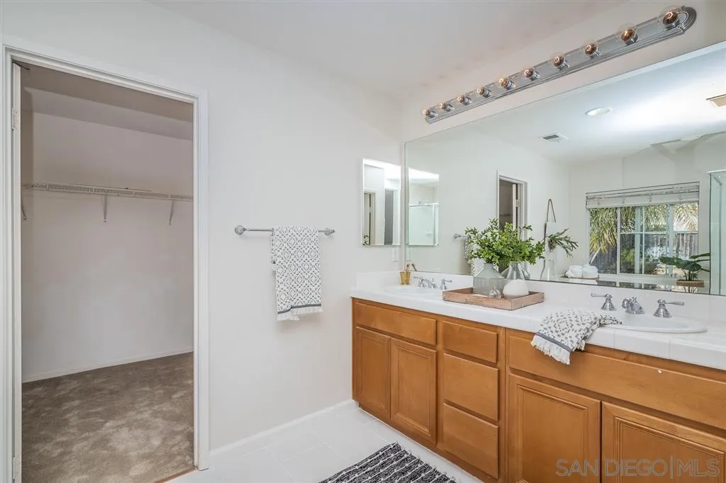 1088 Greenway Road Oceanside, CA 92057 - Photo 14 of 25 a bathroom with a sink and a mirror
