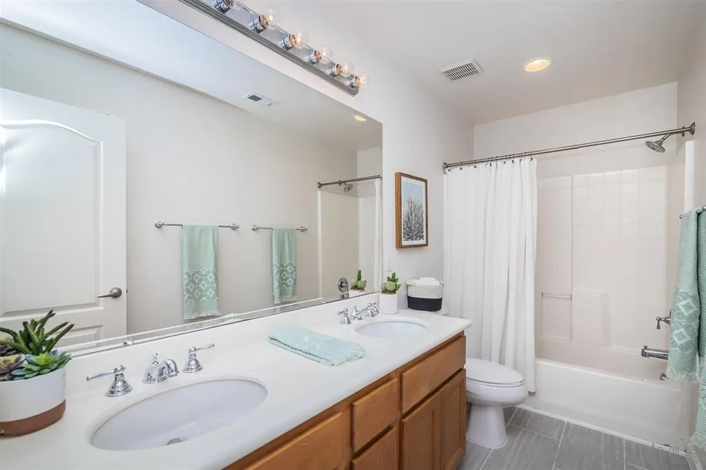 1088 Greenway Road Oceanside, CA 92057 - Photo 18 of 25 a bathroom with a granite countertop sink and a mirror
