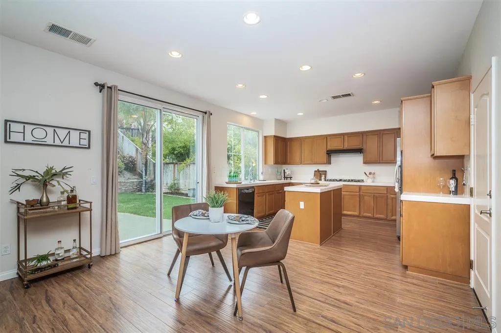 1088 Greenway Road Oceanside, CA 92057 - Photo 5 of 25 a dining room with furniture and a wooden floor