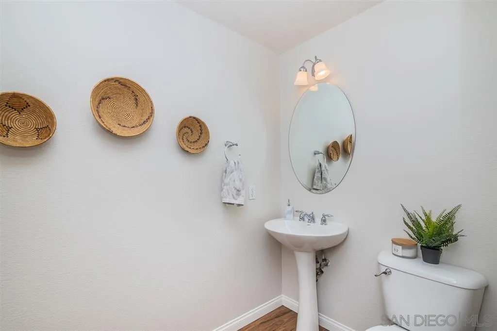 1088 Greenway Road Oceanside, CA 92057 - Photo 9 of 25 a bathroom with a toilet sink and mirror
