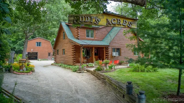 a view of a house with a yard and sitting area