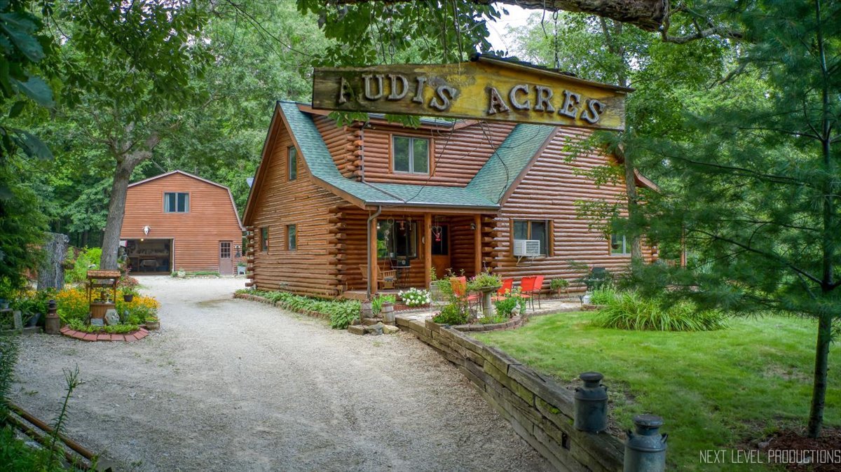 a view of a house with a yard and sitting area