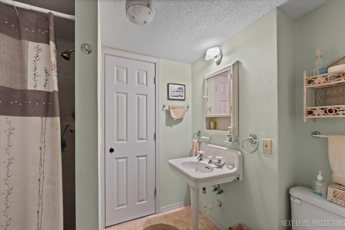 4002 East 1950th Road Sheridan, IL 60551 - Photo 24 of 35 a bathroom with a sink a mirror and a toilet