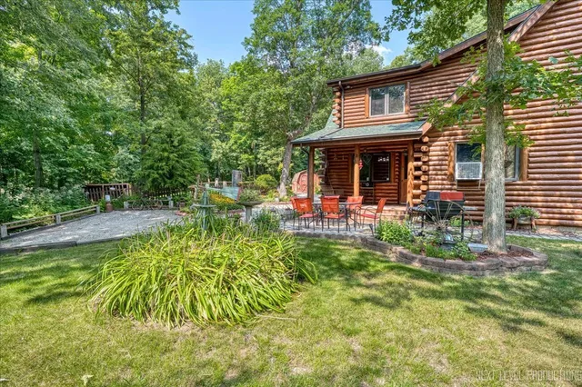 a view of house with a yard and sitting area