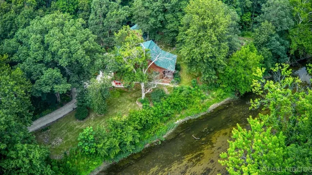 a backyard of a house with lots of green space and trees