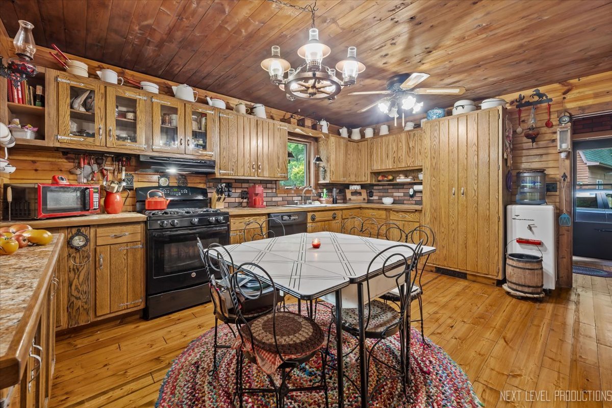 4002 East 1950th Road Sheridan, IL 60551 - Photo 6 of 35 a kitchen with stainless steel appliances granite countertop a stove a refrigerator a oven a dining table and chairs with wooden floor