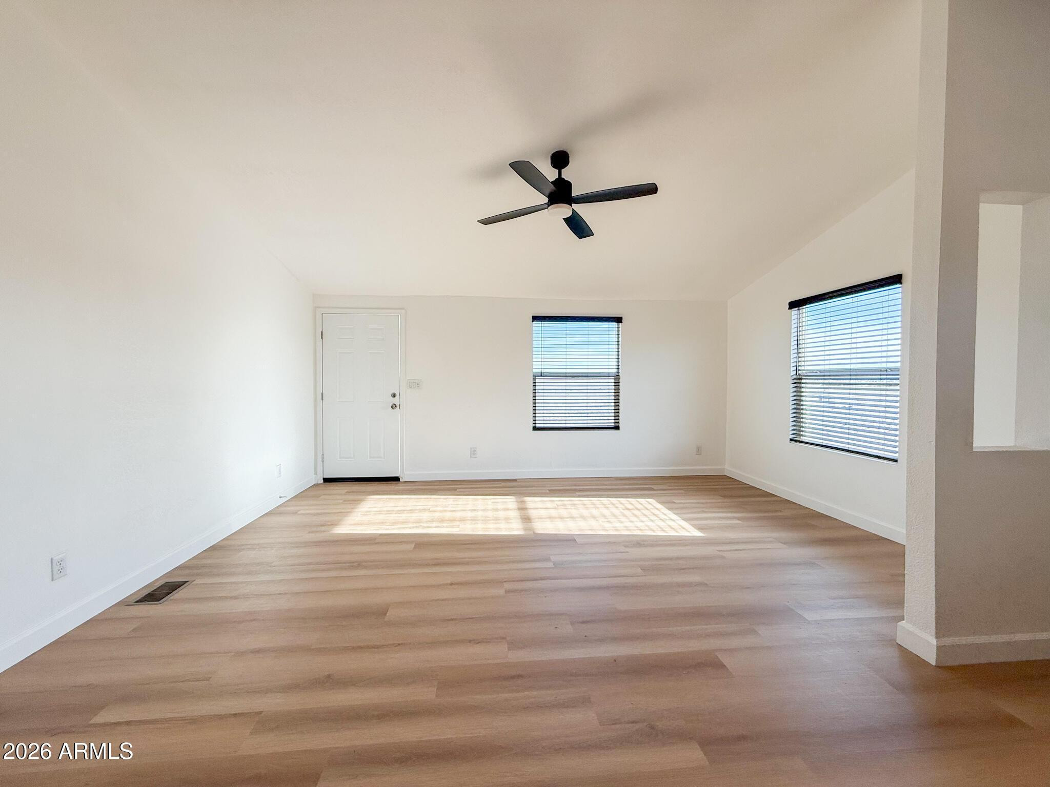 51880 North Gold Plains Road Seligman, AZ 86337 - Photo 12 of 24 a view of empty room with wooden floor and fan