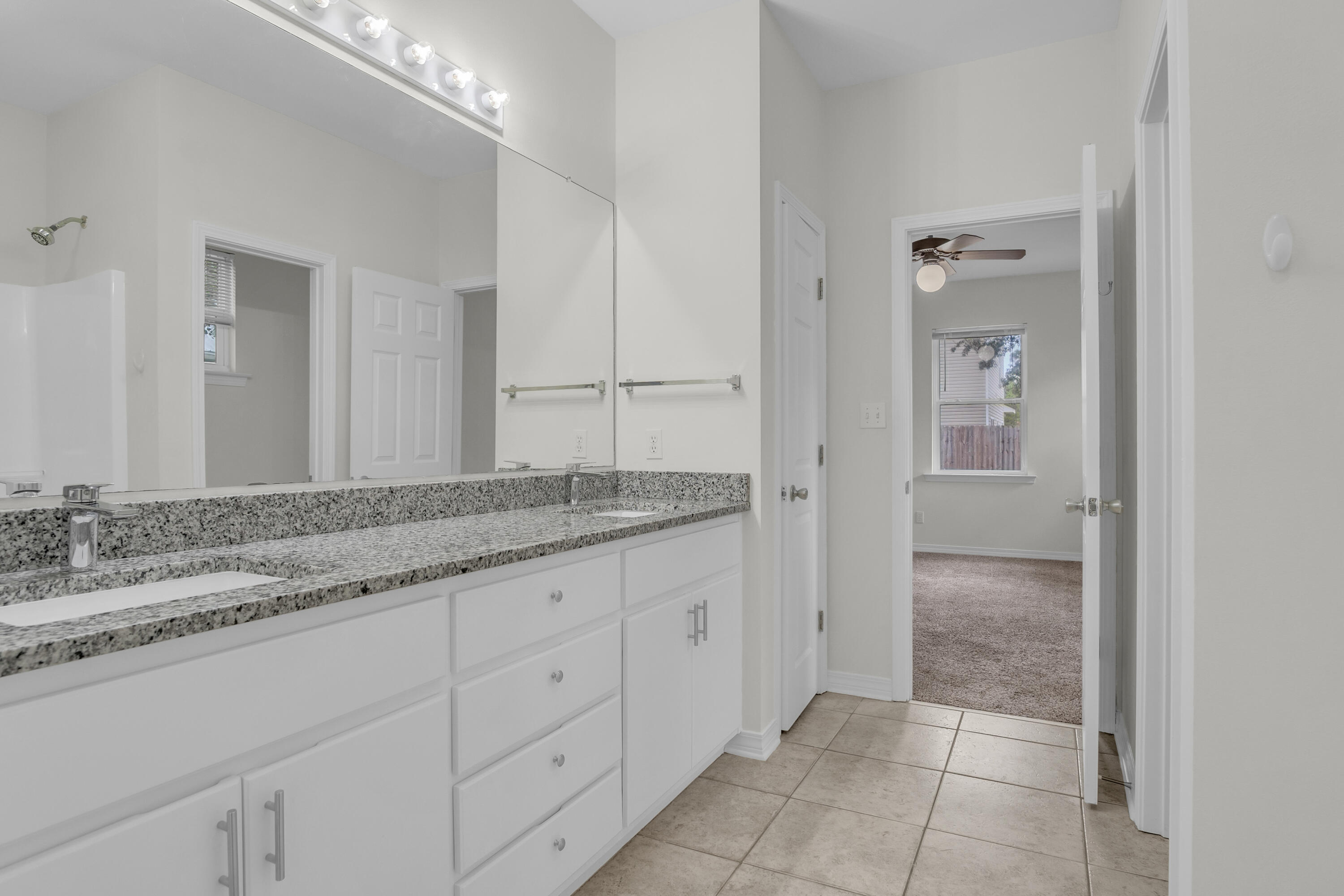 63 Las Roblas Grande Drive Santa Rosa Beach, FL 32459 - Photo 11 of 28 a bathroom with a granite countertop sink and a mirror