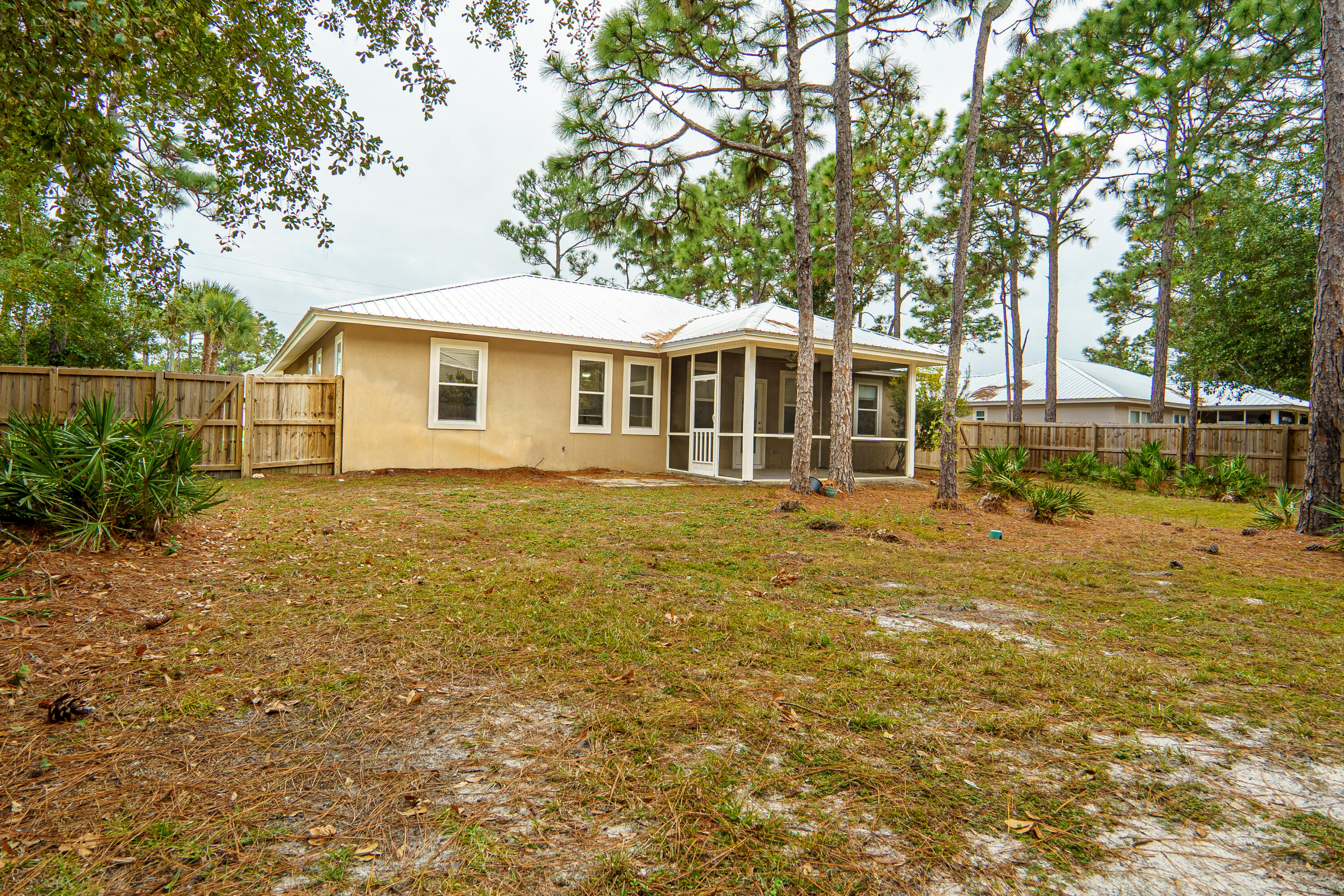 63 Las Roblas Grande Drive Santa Rosa Beach, FL 32459 - Photo 2 of 28 a front view of a house with garden