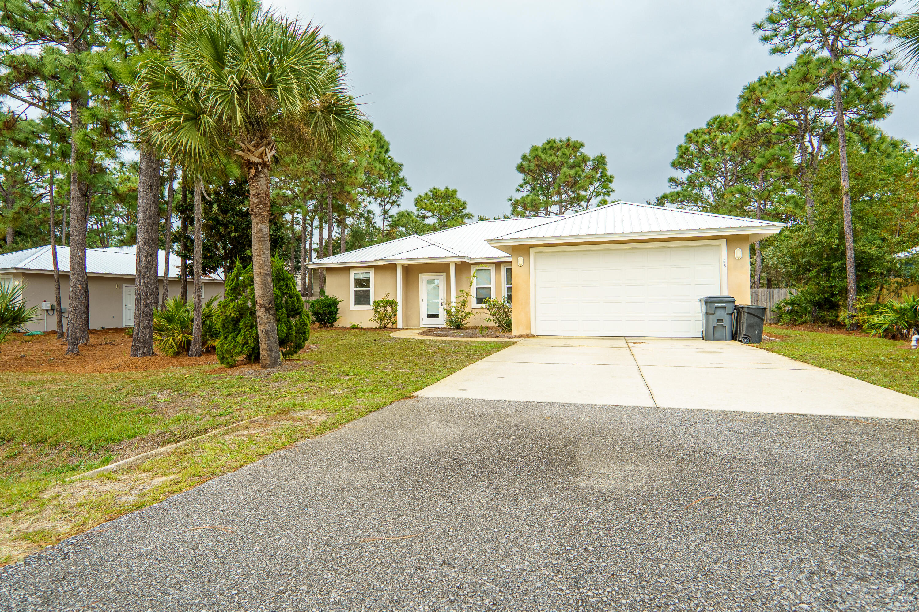 63 Las Roblas Grande Drive Santa Rosa Beach, FL 32459 - Photo 4 of 28 a house with trees in front of it