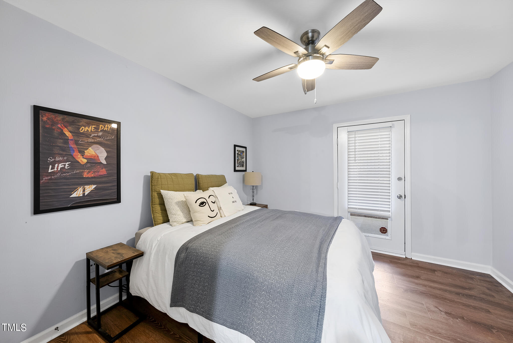 1309 Hillbrow Lane, Unit 103 Raleigh, NC 27615 - Photo 14 of 25 a bed room with a bed and a ceiling fan