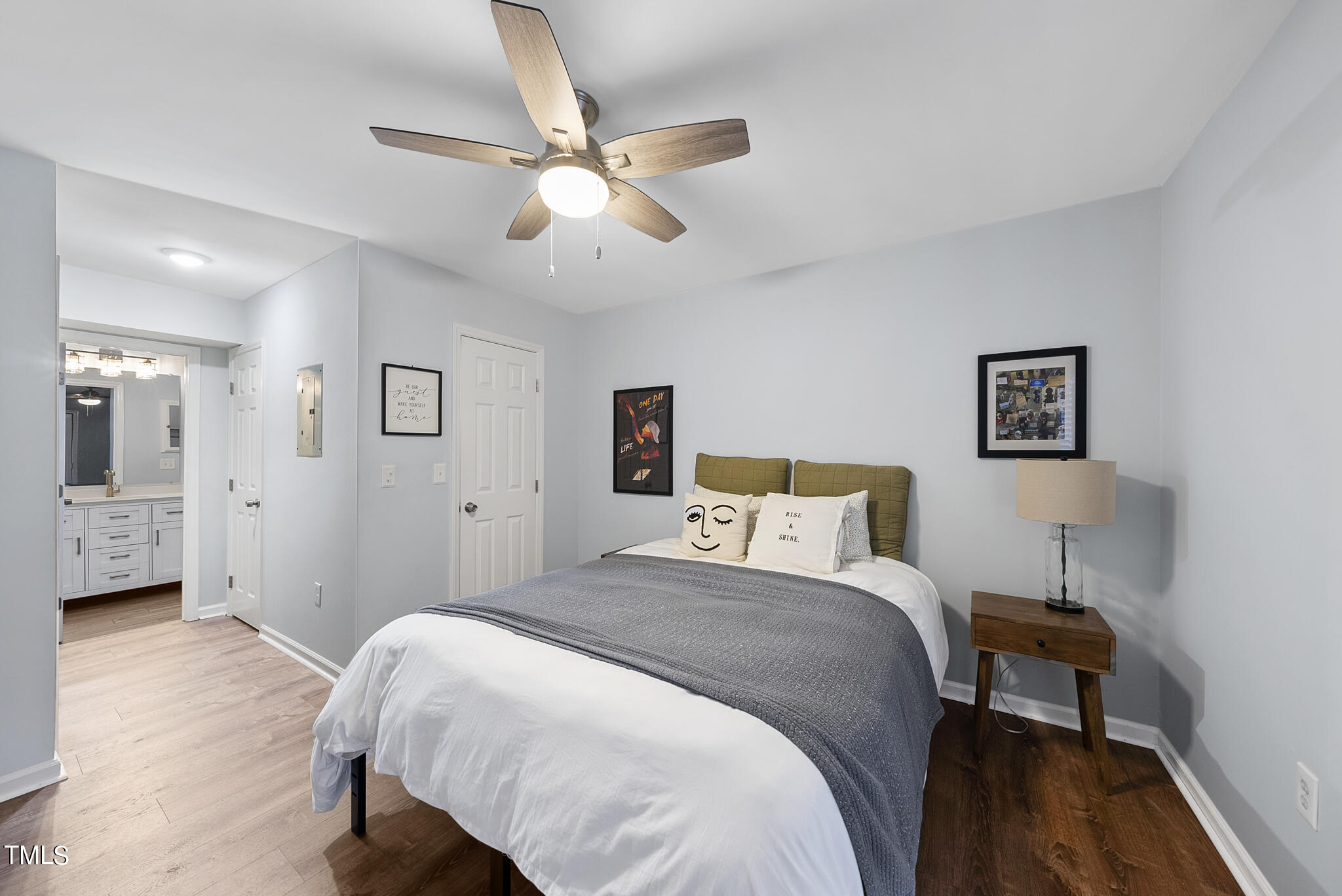 1309 Hillbrow Lane, Unit 103 Raleigh, NC 27615 - Photo 15 of 25 a bedroom with a bed and a chandelier