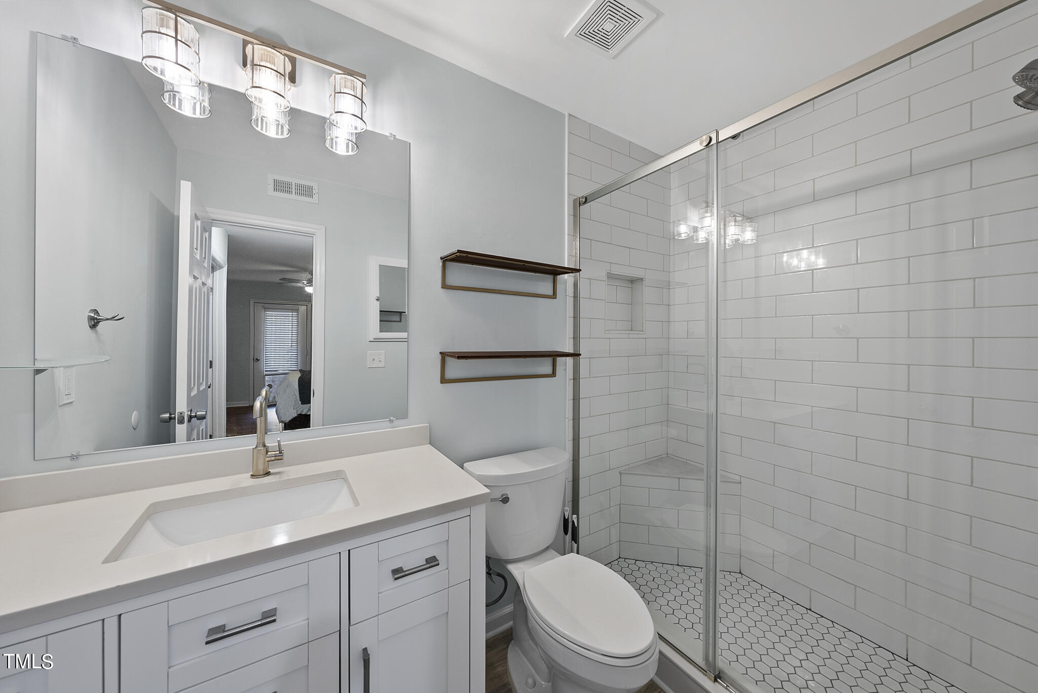 1309 Hillbrow Lane, Unit 103 Raleigh, NC 27615 - Photo 16 of 25 a bathroom with a sink a toilet and shower
