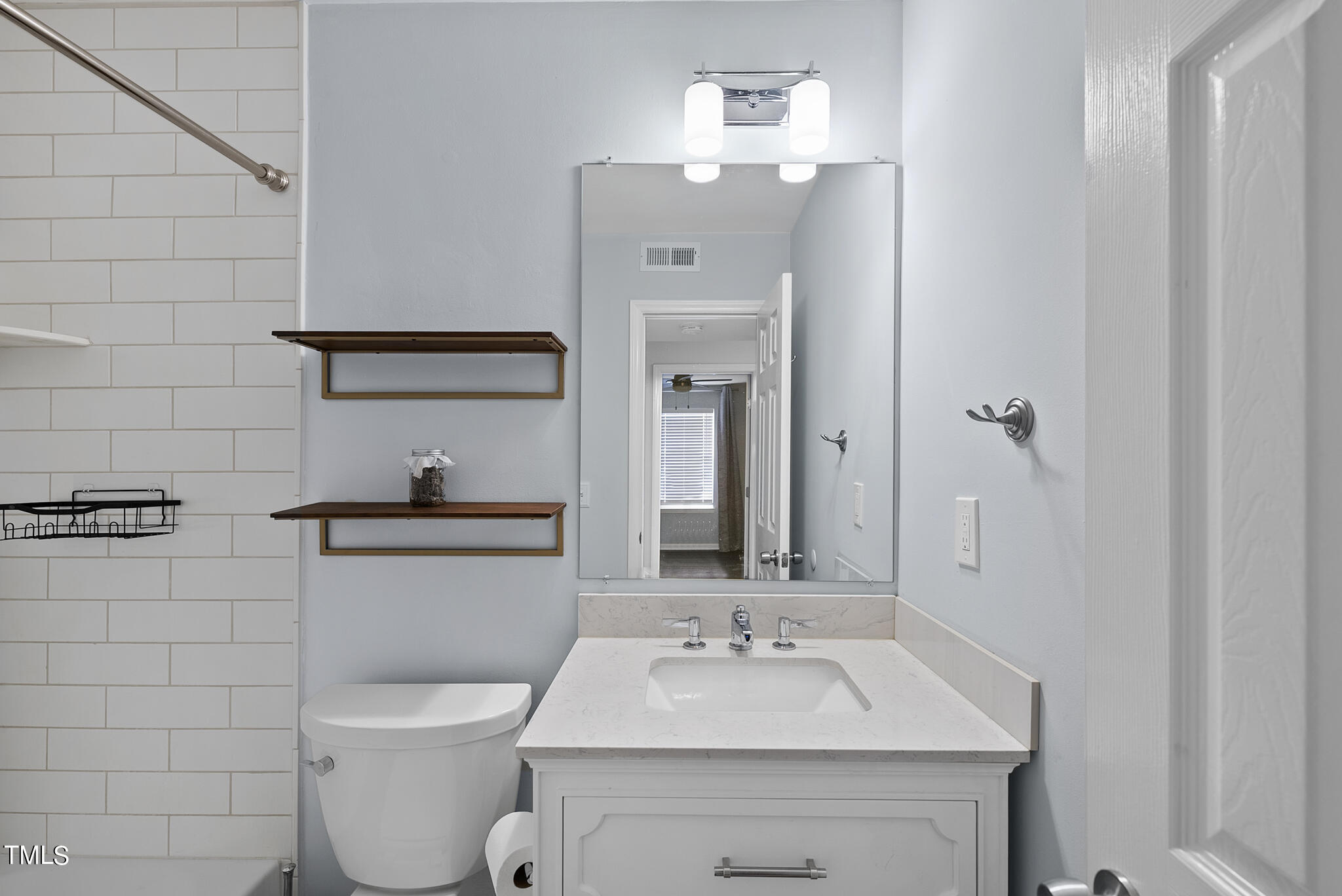 1309 Hillbrow Lane, Unit 103 Raleigh, NC 27615 - Photo 21 of 25 a bathroom with a toilet sink and mirror