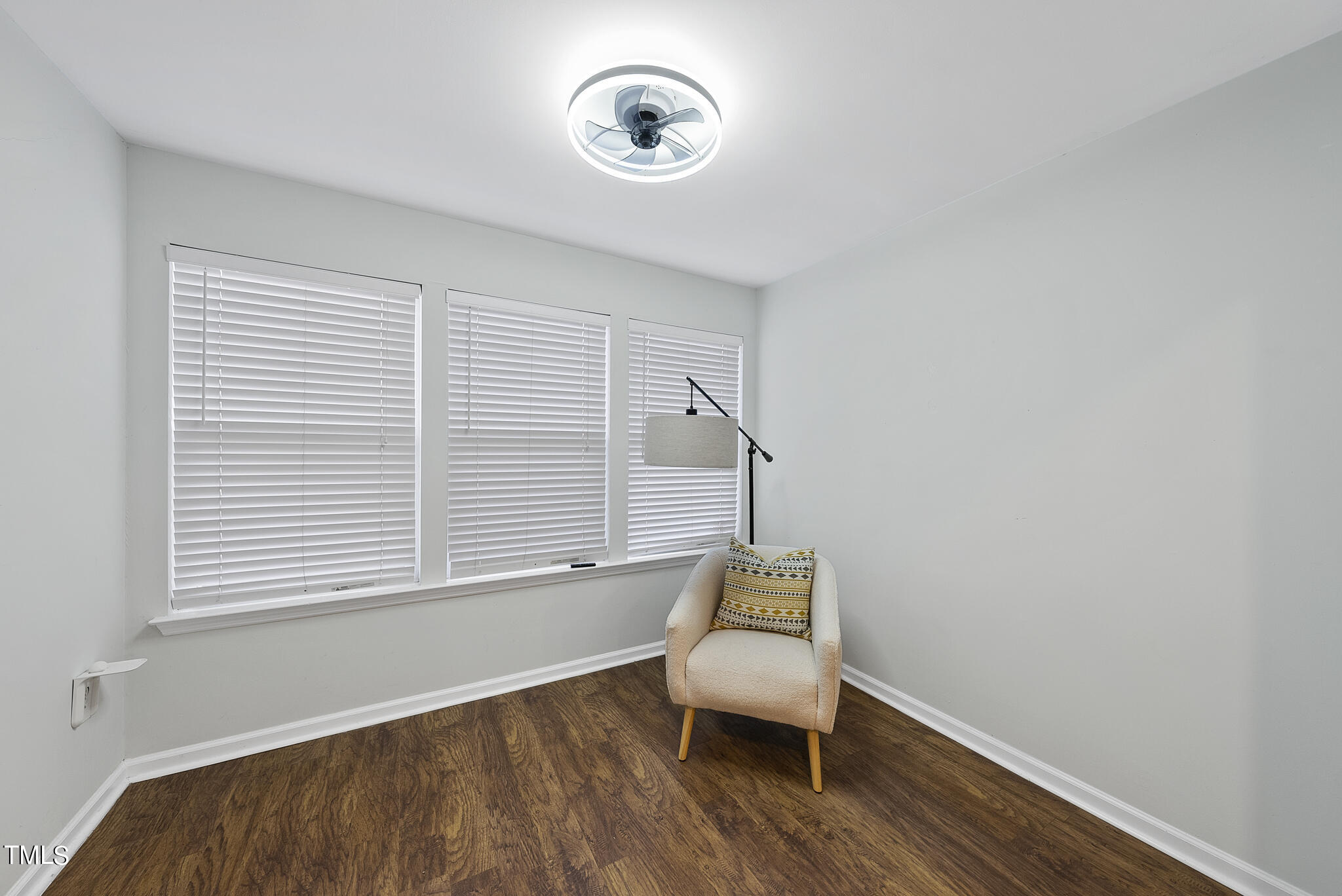 1309 Hillbrow Lane, Unit 103 Raleigh, NC 27615 - Photo 23 of 25 a living room with a chair and a window