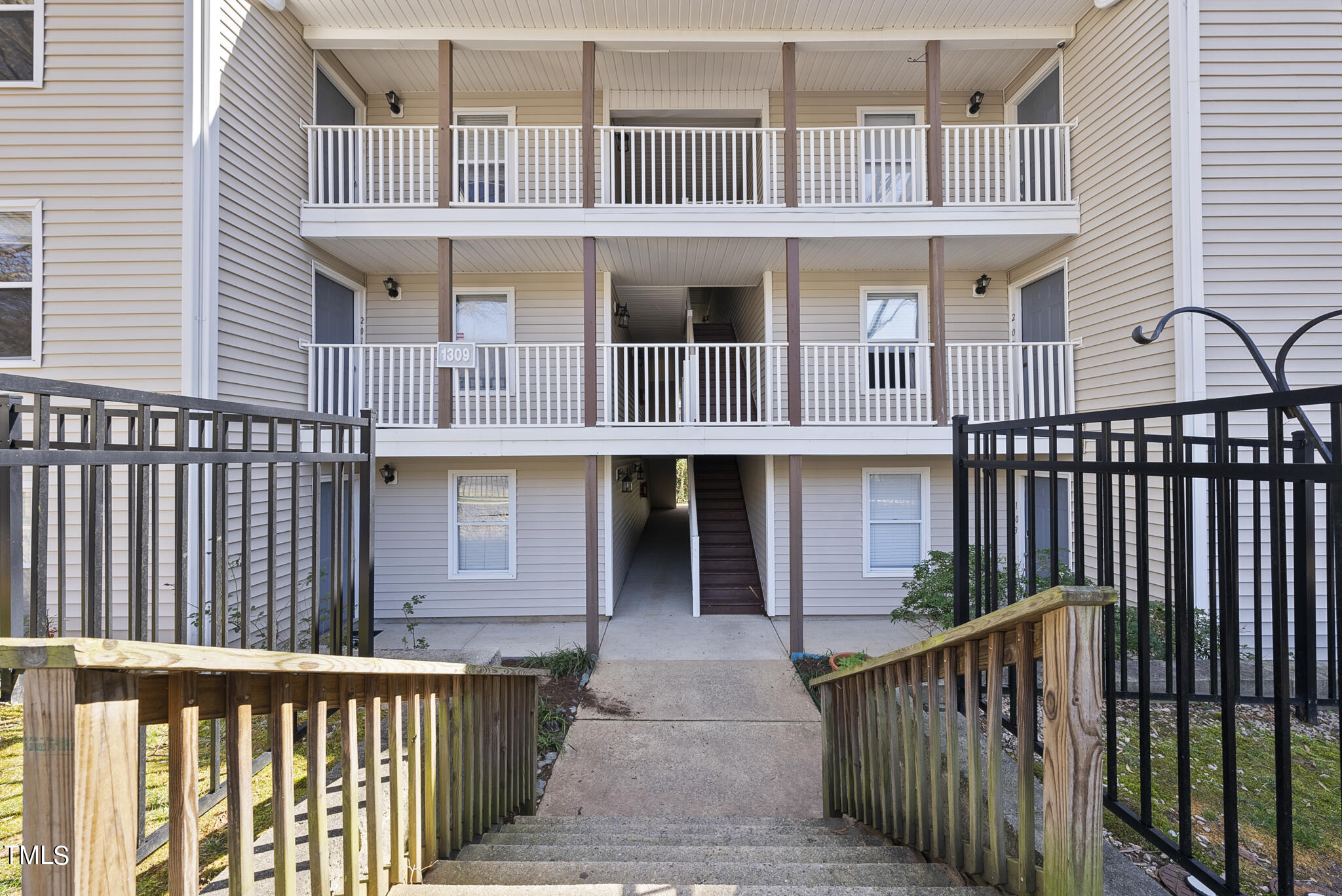 1309 Hillbrow Lane, Unit 103 Raleigh, NC 27615 - Photo 4 of 25 a front view of a house with a porch