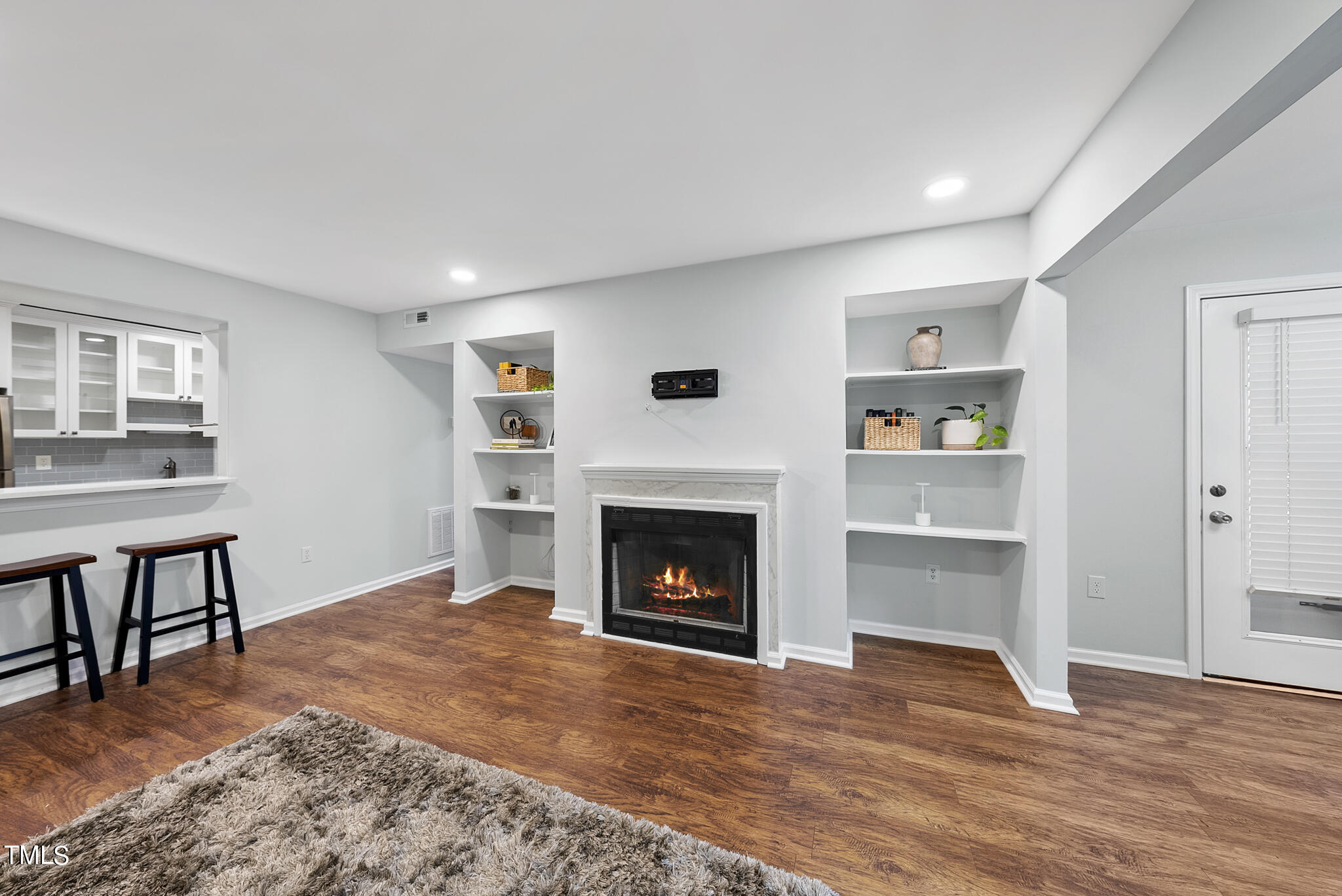 1309 Hillbrow Lane, Unit 103 Raleigh, NC 27615 - Photo 5 of 25 a living room with furniture and a fireplace