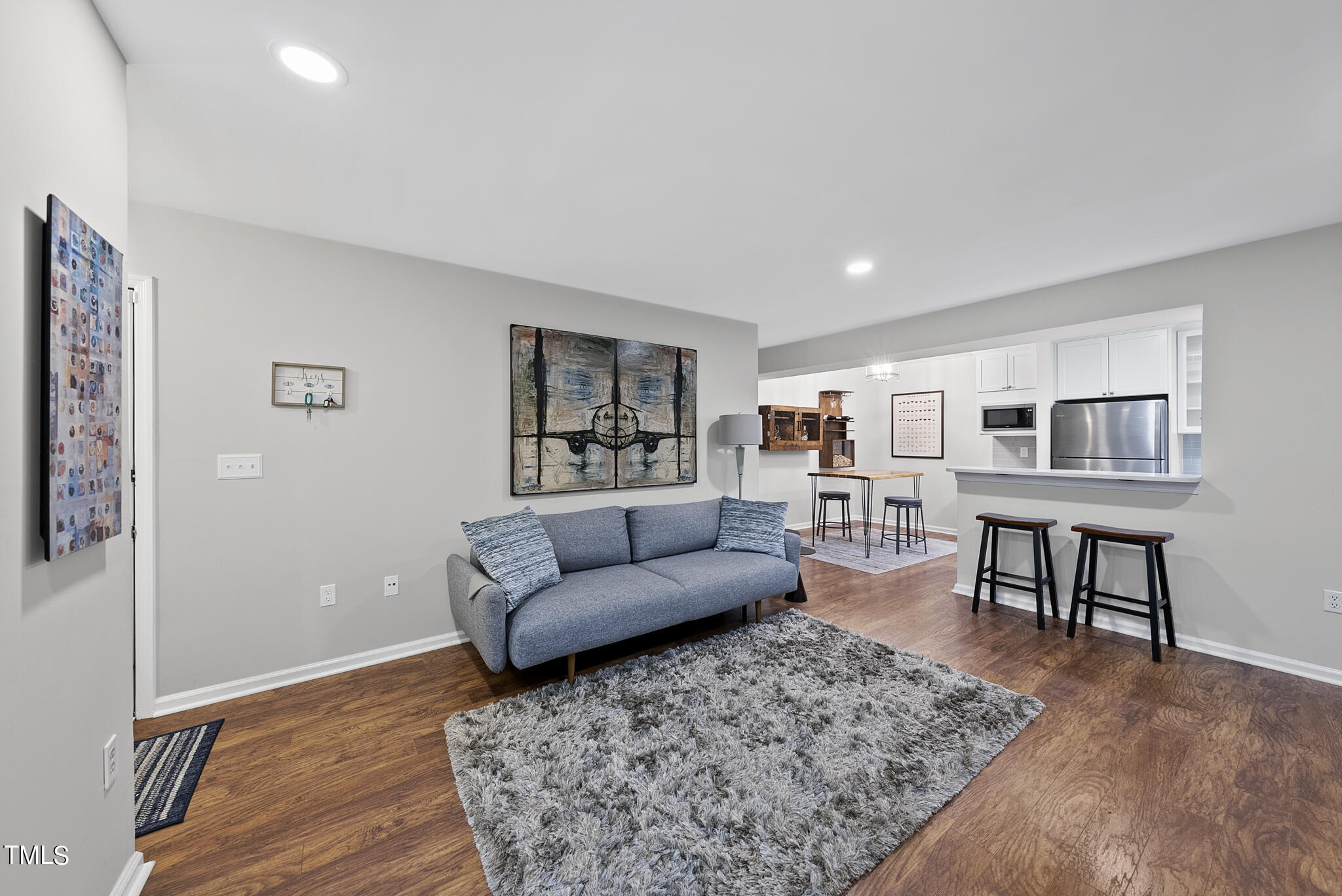 1309 Hillbrow Lane, Unit 103 Raleigh, NC 27615 - Photo 6 of 25 a living room with furniture and a wooden floor