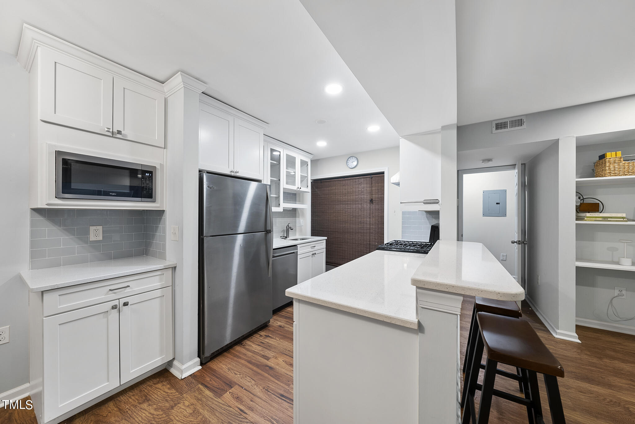 1309 Hillbrow Lane, Unit 103 Raleigh, NC 27615 - Photo 8 of 25 a kitchen with stainless steel appliances a refrigerator stove microwave and cabinets