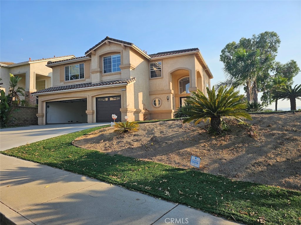 16295 Sun Summit Drive Riverside, CA 92503 - Photo 1 of 1 a front view of a house with a garden and yard