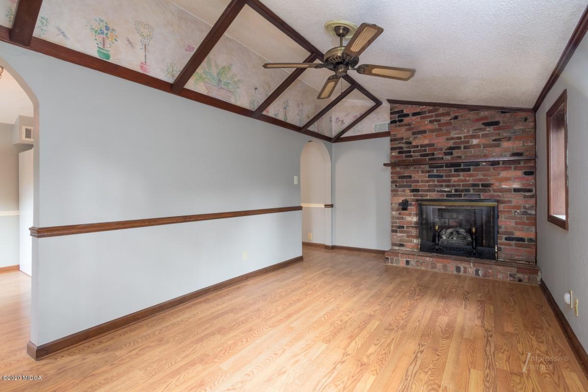 6663 Goodall Mill Road Macon, GA 31216 - Photo 12 of 31 a view of an empty room with wooden floor fireplace and a window