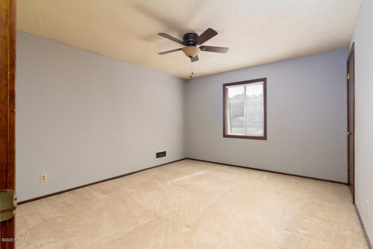 6663 Goodall Mill Road Macon, GA 31216 - Photo 17 of 31 an empty room with windows and ceiling fan