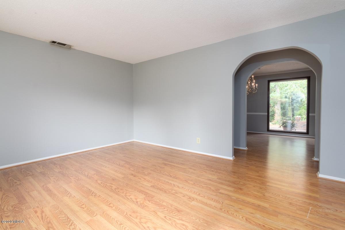 6663 Goodall Mill Road Macon, GA 31216 - Photo 3 of 31 an empty room with wooden floor and windows