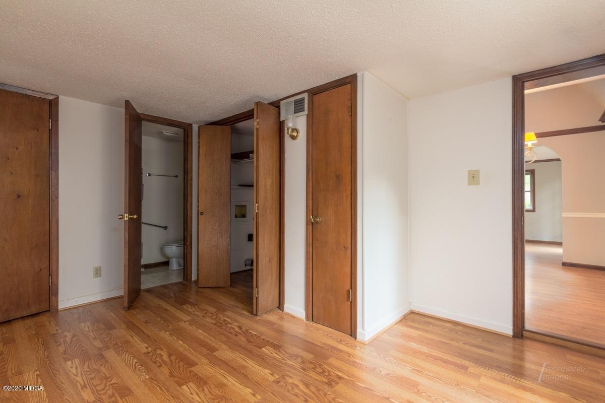 6663 Goodall Mill Road Macon, GA 31216 - Photo 23 of 31 a view of an empty room with wooden floor and a bathroom