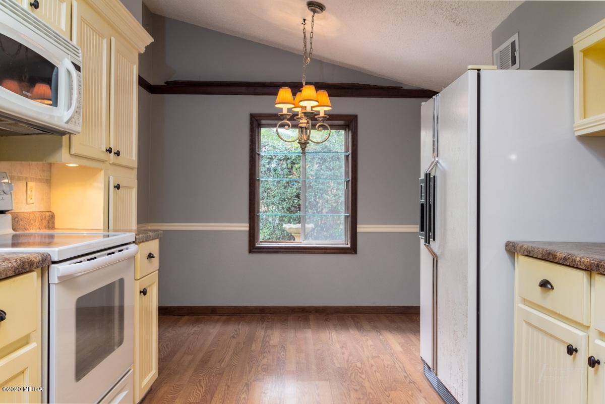 6663 Goodall Mill Road Macon, GA 31216 - Photo 7 of 31 a kitchen with stainless steel appliances a stove a refrigerator and a window