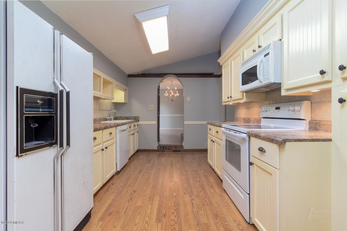 6663 Goodall Mill Road Macon, GA 31216 - Photo 8 of 31 a kitchen with stainless steel appliances granite countertop a stove and a refrigerator