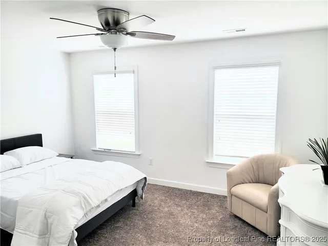 a bedroom with a bed furniture and a window