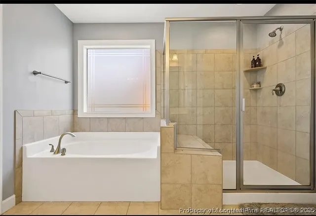 a white bath tub sitting next to a shower