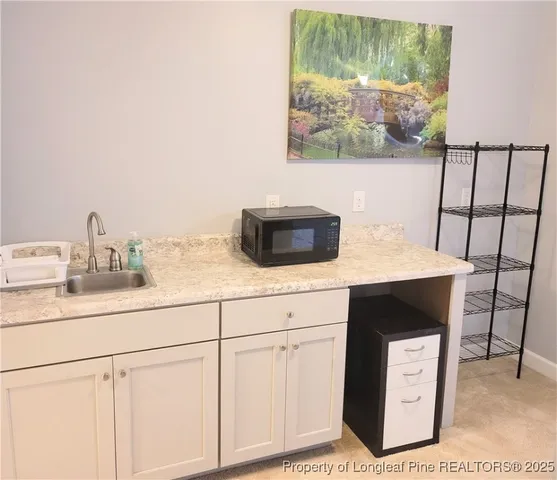 a kitchen with a sink cabinets and a fireplace