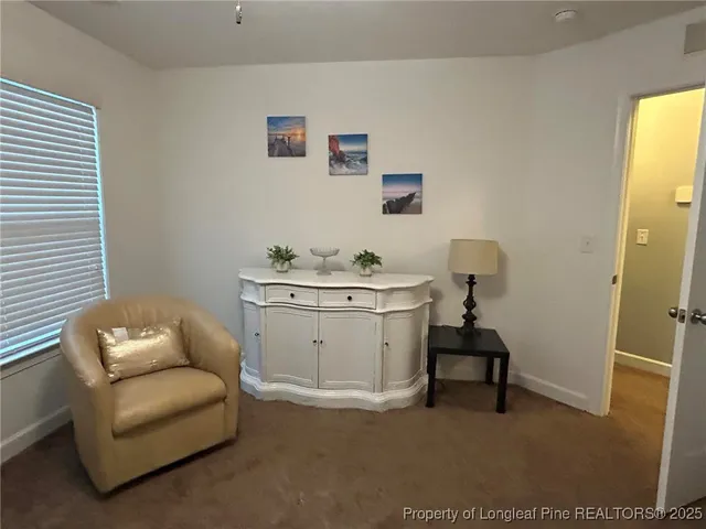 a bedroom with bed couch and window