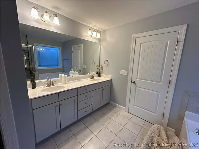 a bedroom with a bed and a ceiling fan