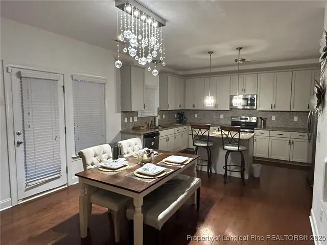a view of a dining room with furniture and wooden floor