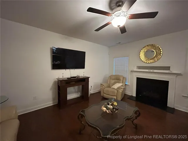 a living room with furniture a fireplace and a flat screen tv
