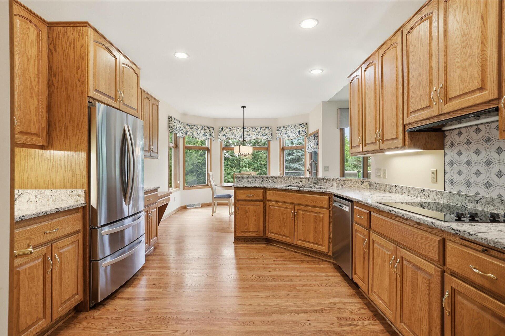 W330-s1417 County Rd C Delafield, WI 53018 - Photo 9 of 39 Kitchen w/NEW Quartz Counters, SS Appliances, Wood Floors, & Pantry