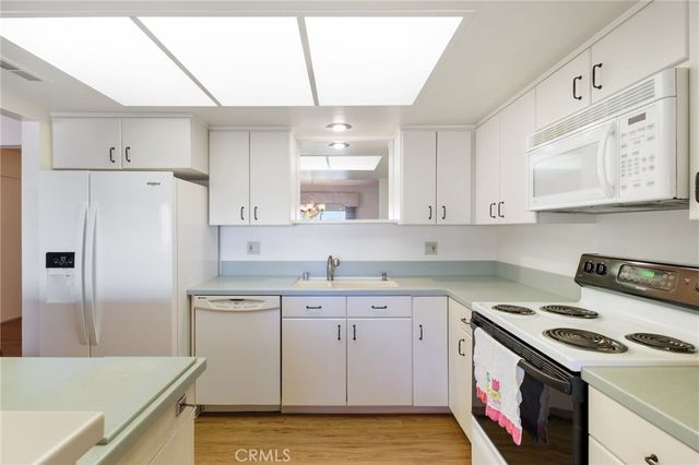 a kitchen with a stove a sink and a refrigerator