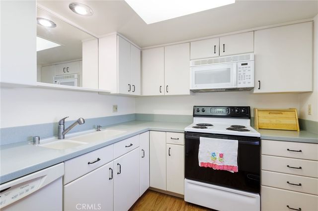 a kitchen with cabinets appliances and a sink