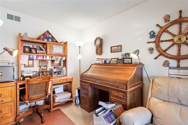a living room with furniture a rug and a window