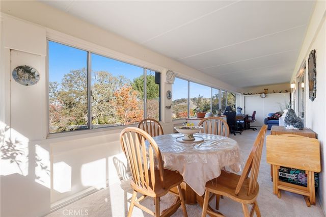 a dining room with furniture a window and a ocean view