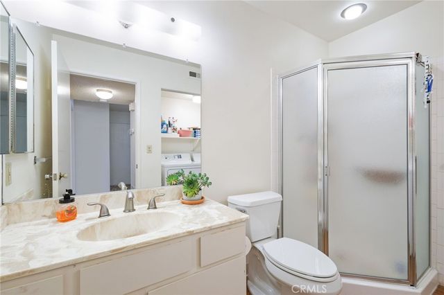 a bathroom with a sink toilet vanity and shower