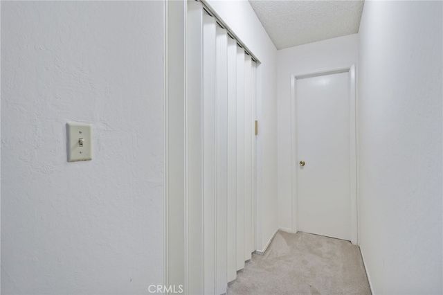 a view of walk in closet with clothes