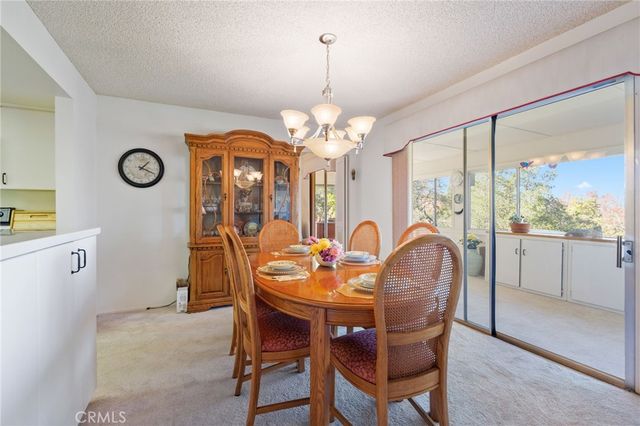 a dining room with furniture a large window and a clock