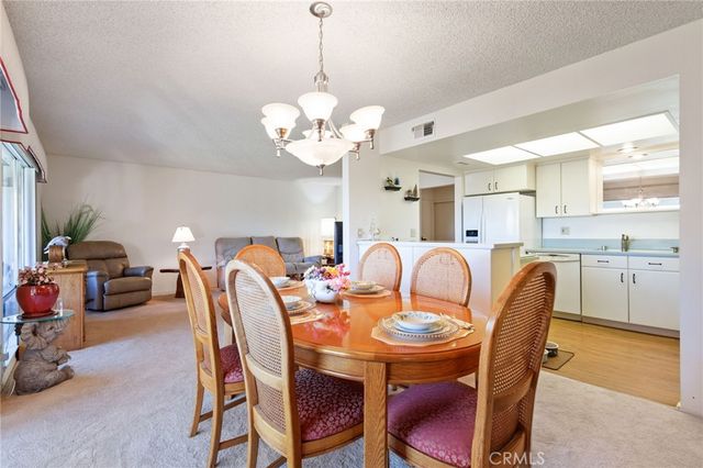a view of a dining room with furniture and chandelier